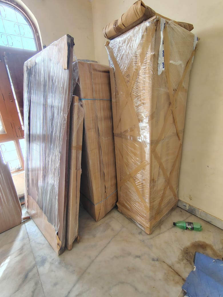 Chhavi Packers and Movers Team Unloading Furniture - Safe Goods Handling
